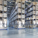 Huge distribution warehouse with high shelves and forklift