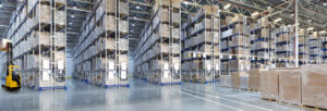 Huge distribution warehouse with high shelves and forklift
